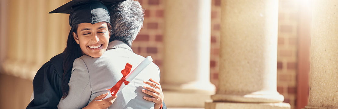 A woman hugging at her graduation.