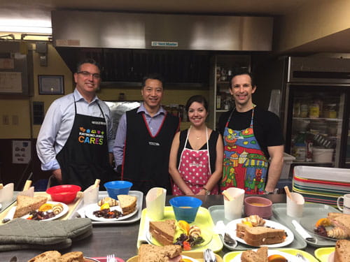 4 people wearing aprons at an event